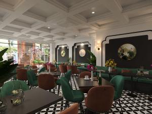 a restaurant with green chairs and tables in a room at Light Vesper Premium Hotel & Sky Bar in Ho Chi Minh City