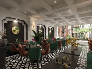 a restaurant with green chairs and tables in a room at Light Vesper Premium Hotel & Sky Bar in Ho Chi Minh City