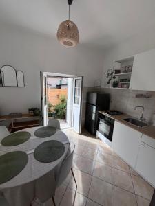 a kitchen and dining room with a table in a room at Casa Albe in Massa dʼAlbe