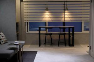 a dining room with a table and chairs and a window at Jasmin Nishikimachi III - Vacation STAY 13079v in Takamatsu