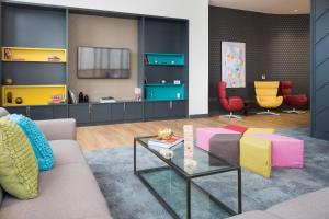 a living room with a couch and a table and chairs at The Ascent in Liverpool