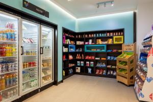 a store aisle with refrigerators and shelves of food at The Ascent in Liverpool