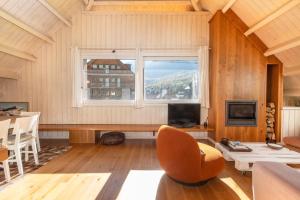 a living room with a large window and a couch at Magnifico duplex en centro Viella in Vielha