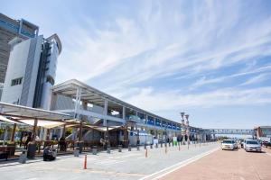 a large building with cars parked in a parking lot at Jasmin Jasmin Nishikimachi I - Vacation STAY 11175v in Takamatsu