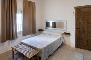 a small bedroom with a bed and a mirror at Montijo Relax and Sunny Private Pool in Cádiz +81 photos