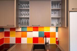 a kitchen with colorful tile on the wall at Anupro Villa in Trakai +28 photos