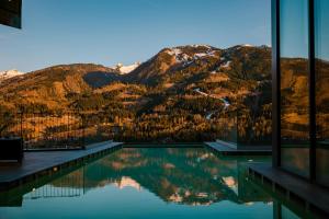 a swimming pool with a view of a mountain at La Roccia Wellness Hotel in Cavalese