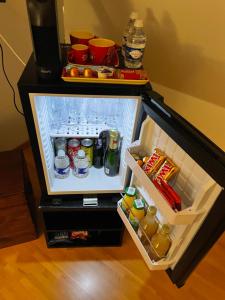 a small refrigerator with its door open with drinks at La chambre d hôtes By Georges in Scharrachbergheim Irmstett