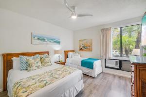 a bedroom with two beds and a window at Grand Champions 163 · GC 163 2BD Wailea Condo w AC Pool Close to in Wailea +42 photos