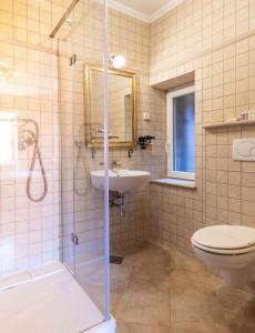 a bathroom with a shower and a sink and a toilet at Antaeus Residence in Dubrovnik