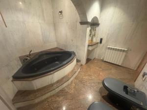 a bathroom with a bath tub and a toilet at Casa Raval Artés in Artés +7 photos