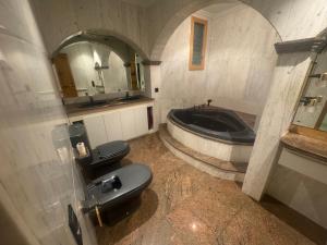 a bathroom with a toilet and a bath tub at Casa Raval Artés in Artés