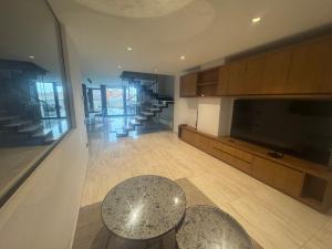 a living room with a table and a television at Casa Raval Artés in Artés