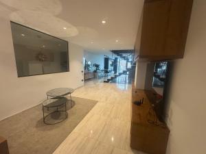 a living room with a table and a staircase at Casa Raval Artés in Artés