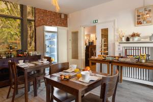 a kitchen and dining room with tables and chairs at Logis Hôtel Saint Cyr in La Ferté-Saint-Cyr