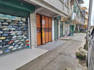 a shop with a display of shoes on a street at TN's Basecamp Hostel in Tawang