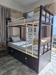 a couple of bunk beds in a room at TN's Basecamp Hostel in Tawang
