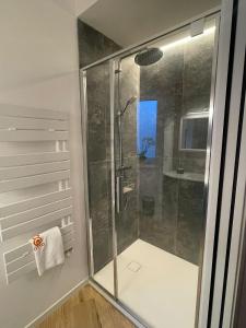 a shower with a glass door in a bathroom at Otto House short stay with style in San Daniele del Friuli +14 photos