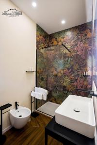 a bathroom with a sink and a wall mural at Palazzo dei Conti in Naples