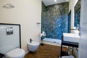 a bathroom with a toilet and a sink and a shower at Palazzo dei Conti in Naples +29 photos