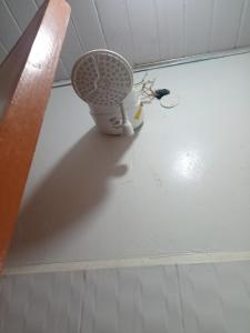 a fan sitting on the floor in a room at Cozy Studio in Rungiri