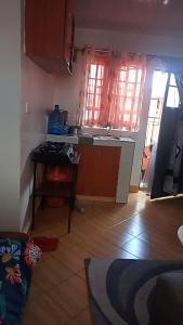 a kitchen with a sink and a table in a room at Cozy Studio in Rungiri