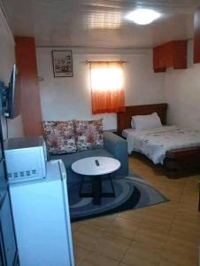 a small room with a table and a bed at Cozy Studio in Rungiri