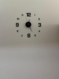 a white clock with black numbers on a white background at Pine forest apartments in Pamporovo