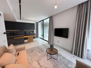 a living room with a couch and a table at SWIFT Suites Limassol in Limassol