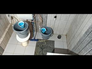 a bathroom with a toilet and a sink at Divine home stays in Madikeri +7 photos