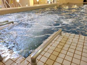 a large swimming pool with water in it at Kur and Hotel Shinshu in Shiojiri