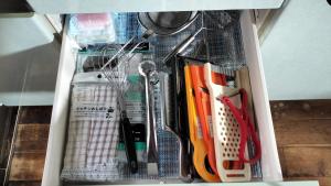 a drawer filled with various kitchen utensils at 古民家ふるさと真鶴 in Wada +50 photos