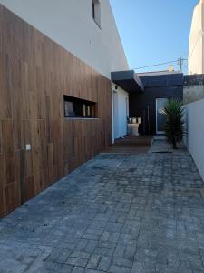 a wooden fence on the side of a building at Attic Apartment in cascais Near The Sea in São Domingos de Rana +8 photos
