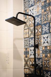 a lamp in a room with a wall with tiles at Villa Doc Let - Your Home in Doc Let in Nha Trang