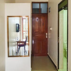 a room with a door and a table with a chair at Lesilale Hotel in Morogoro