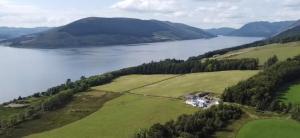 an aerial view of a house on a hill next to a lake at Sunset View in Innellan
