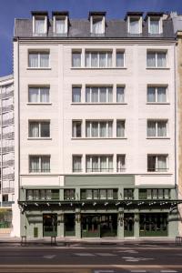 a large white building with a lot of windows at 1.75 Paris Le Charme in Paris