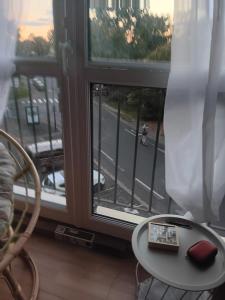 a room with a table and a window with a view of a street at Olembe Garden in Avon