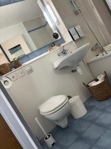 a bathroom with a toilet and a sink at Campanile Dijon Centre - Gare in Dijon
