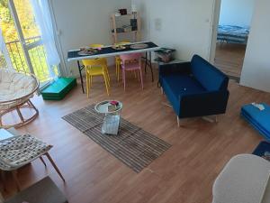 a living room with a blue couch and chairs at Olembe Garden in Avon