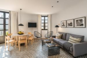 a living room with a couch and a table at Aspasios Poble Nou Apartments in Barcelona