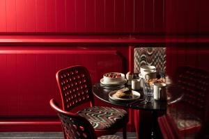 a table with food on it in a red room at 1.75 Paris Le Charme in Paris