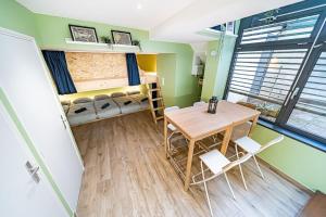 a room with a table and chairs and a bedroom at Sleep and go - unusual accommodation - Saint Genis Laval in Oullins