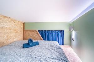 a bedroom with a bed with a blue pillow on it at Sleep and go - unusual accommodation - Saint Genis Laval in Oullins +16 photos
