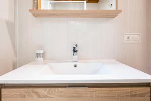 a bathroom with a white sink in a room at Chalet La Petite Maison in Saint-Marcel