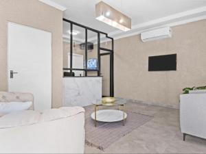 a living room with a couch and a table at Kuhle Guesthouse in Kempton Park +11 photos