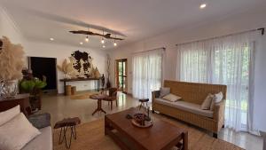 a living room with a couch and a table at Tulivu Kilimanjaro Retreat in Msaranga