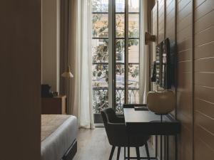 a bedroom with a desk with a computer and a window at Molina Lario in Málaga