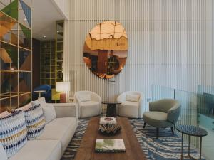 a living room with a couch and chairs and a mirror at Molina Lario in Málaga