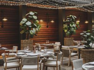 a restaurant with tables and chairs and plants at Molina Lario in Málaga